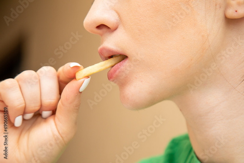 Closeup of woman eating fries
