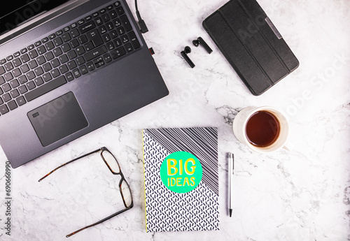 Home office workspace flat lay with laptop, note book and tablet