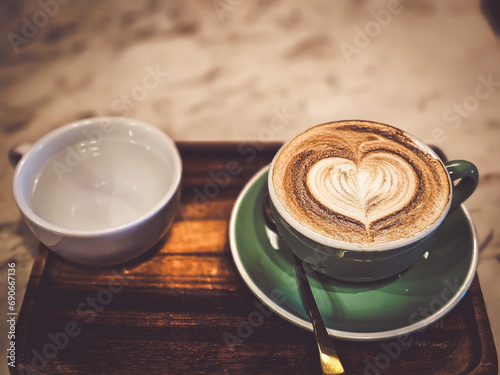 Hot cappuccino coffee in a mug Placed on the table in a warm atmosphere.