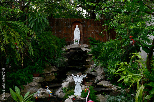 Statue of Our lady of grace virgin Mary view with natural background in the rock cave at Thailand. selective focus. photo