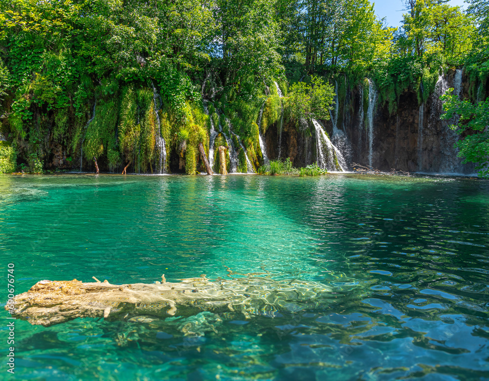 Picturesque waterfall. Waterfall among rocks and forest. Plitvice Lakes, Croatia.