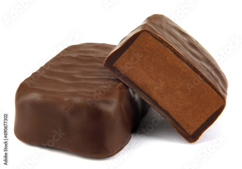 Chocolates candy are isolated on a white background. Whole and half chocolate candy.