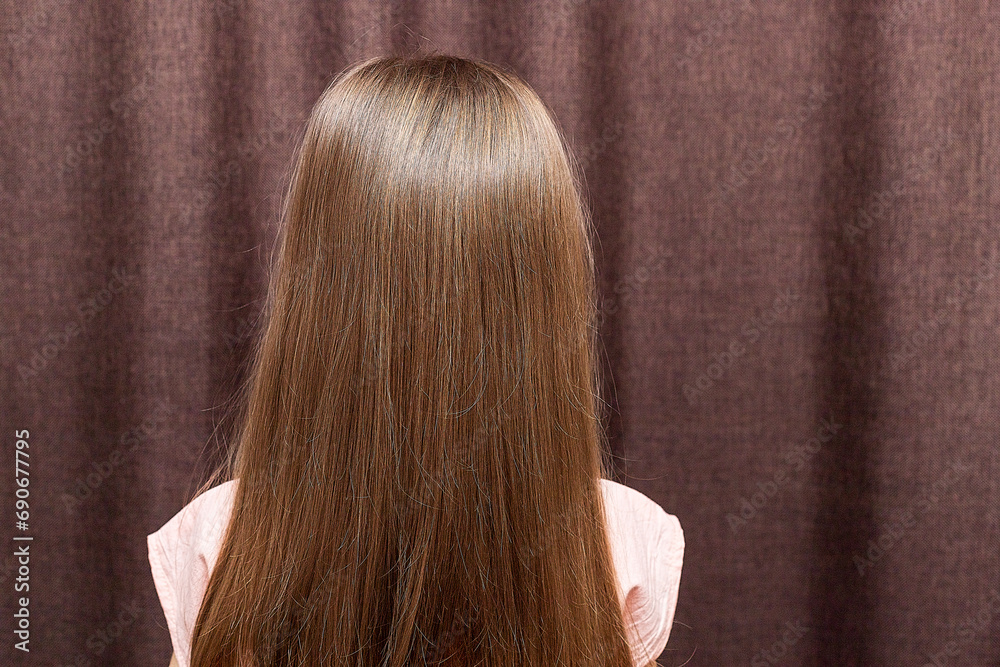 A portrait of a two years old little girl turn back to show her braided hair tied with ribbons. A portrait of a two years old little girl turn back to show her braided hair tied with ribbons.