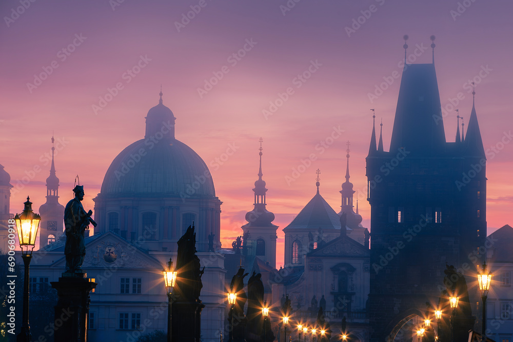 Misty mornig from Charles Bridge. Colorful sunrise over towers of Prague, Czech Republic..