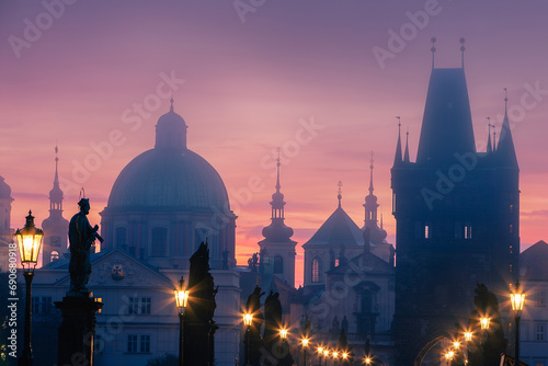 Misty mornig from Charles Bridge. Colorful sunrise over towers of Prague, Czech Republic.. photo