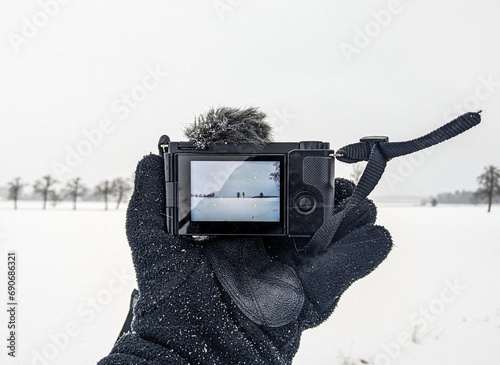 Wallpaper Mural Cropped hand holding a camera during winter Torontodigital.ca