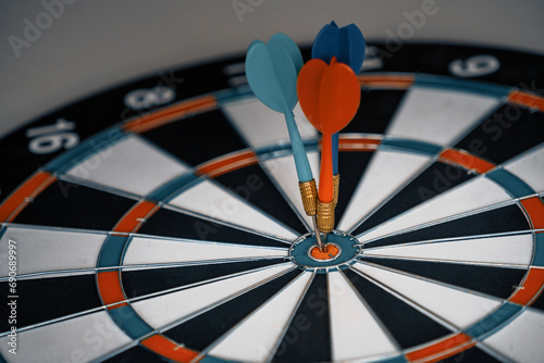 Concept of challenge in business marketing bullseye and intelligent customer reaching. The dart is the strategy or skill. The dartboard is the target or goal. uds