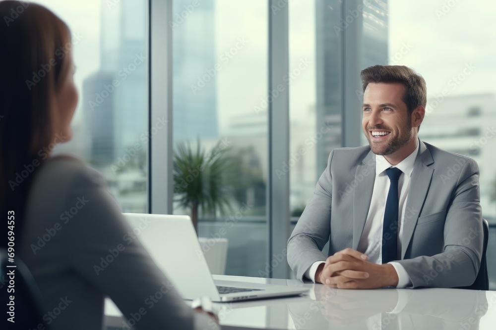 A man sitting at a table talking to a woman A man sitting at a table talking to a woman