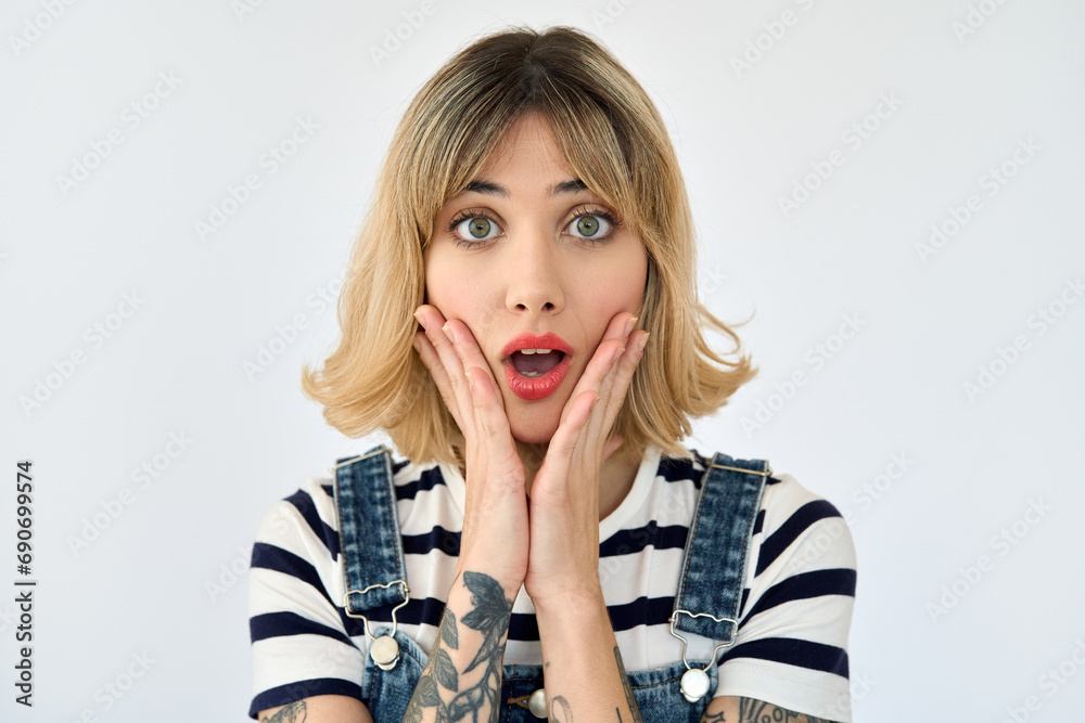 Shocked pretty gen z blonde young woman, surprised 20s girl with short blond hair and tattoos looking at camera feeling amazed or excited emotion isolated on white background. Close up face portrait. - obrazy, fototapety, plakaty 