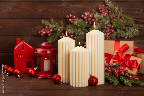 Christmas decoration with candle on texture background. New Year and Christmas candles. Cozy home decor. Burning candle and Christmas decoration. Christmas lights. Copy space.Holiday concept. 