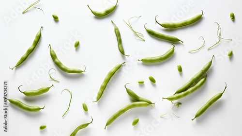 An overhead shot of fresh green beans, scattered randomly, creating a contrast with the white floor.