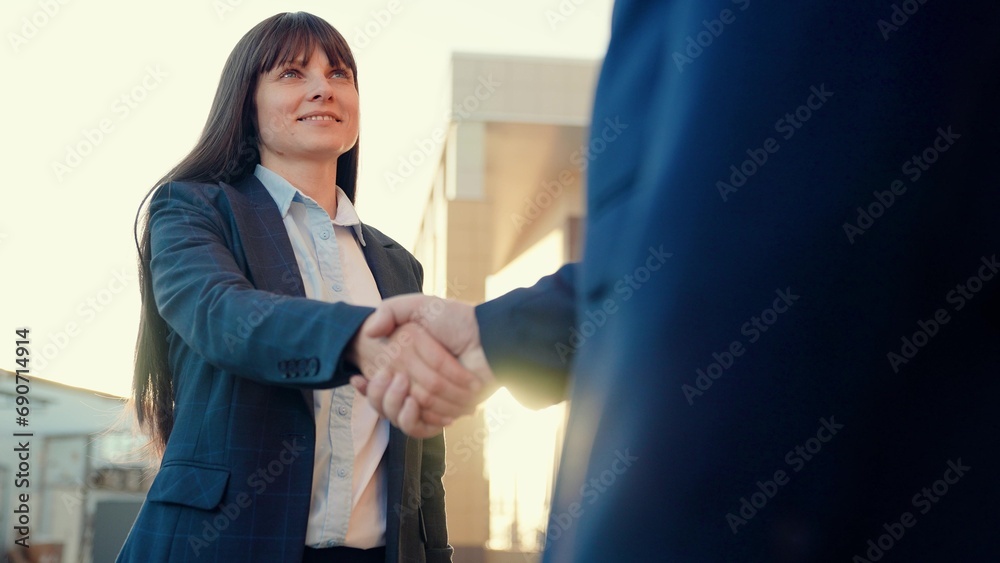 Business people shaking hands, working as team. Business woman shaking hands with partner, successful cooperation under contract. Businessmen in suits greet on street with hand gestures. Politicians
