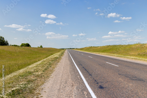 paved road along and blue sky