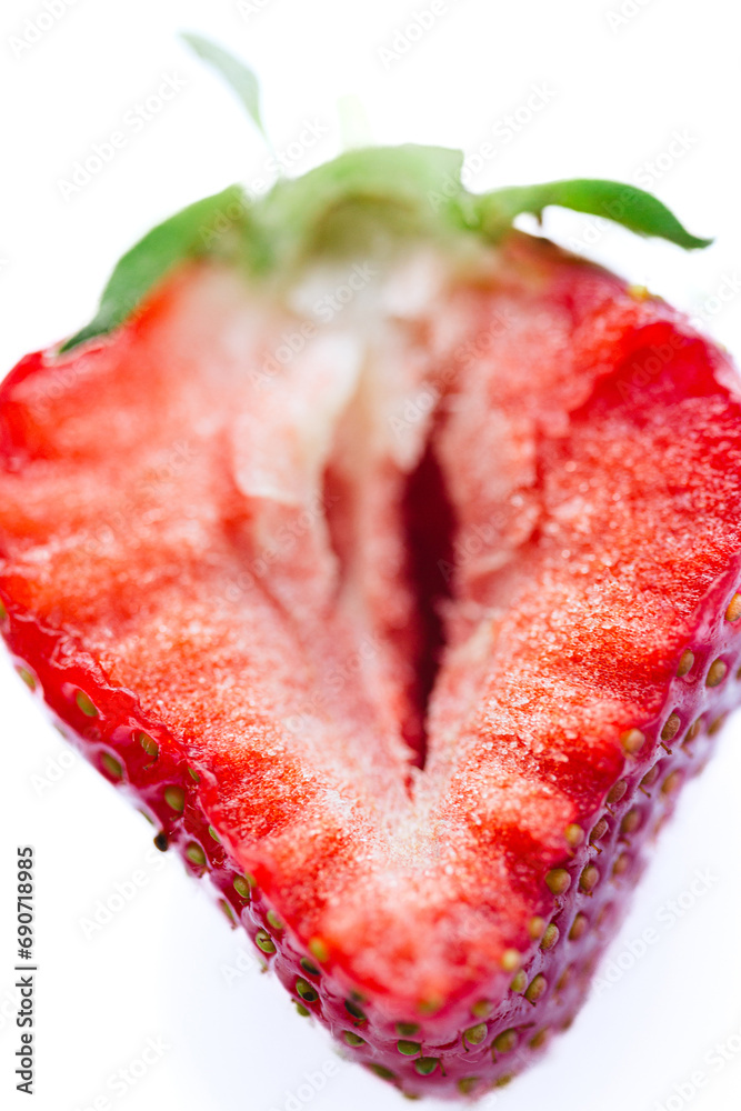 Ripe half of a strawberry on a white background.