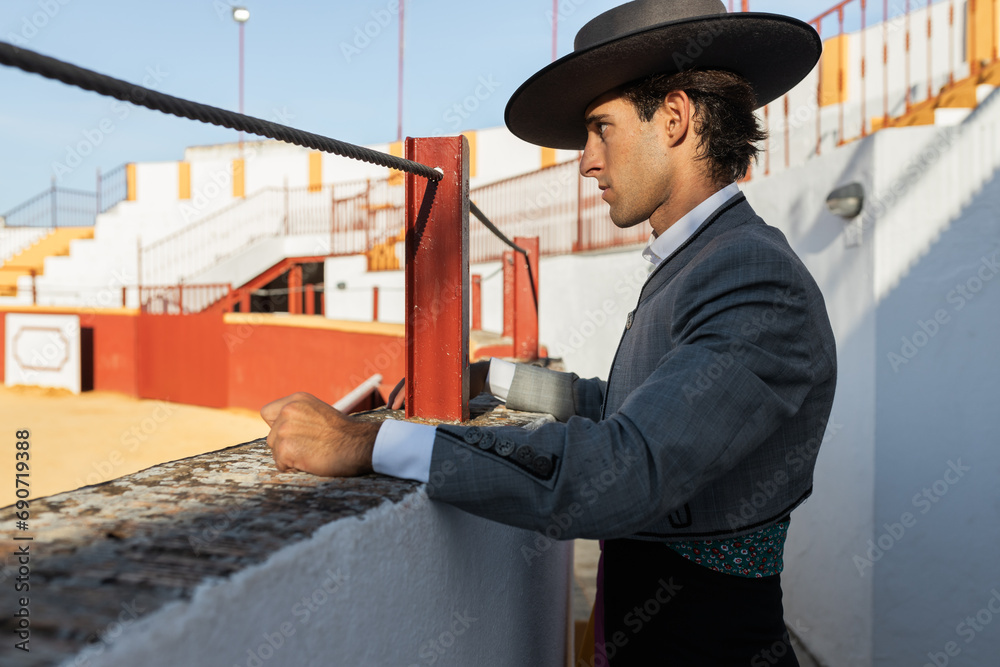 Hispanic torero looking at arena