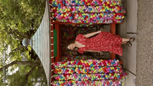 Gorgeous hispanic woman turning in a vibrant dress at yasaka koshindo, celebrating japanese tradition with a joyful spin photo