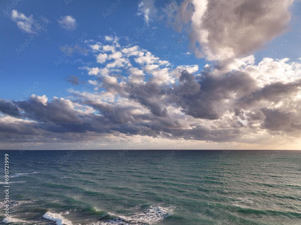 Obraz premium Beautiful Mediterranean warm sunset seascape with clouds, golden blue and purple 