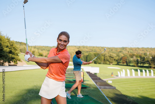 Golfing Harmony: Young Pair on the Green © Andrii 