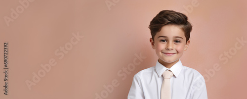 Portrait of a happy child wearing a white dress shirt and a tie against a pastel background