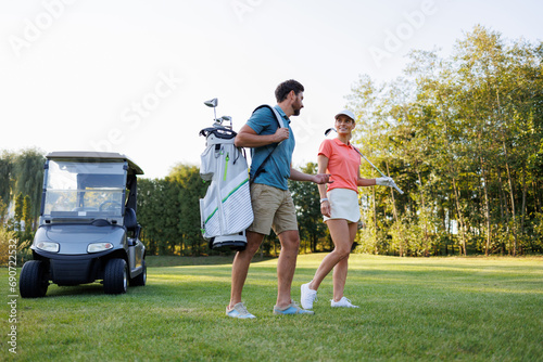 Sporty Duo on the Links with Golf Cart