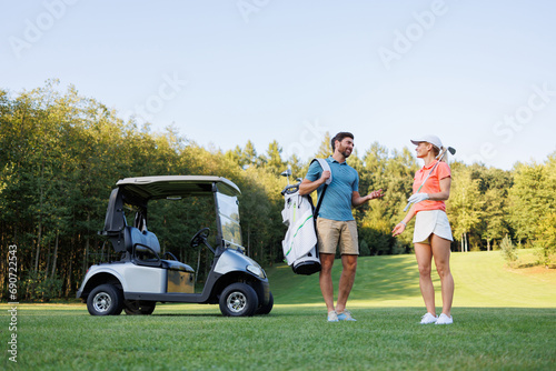 Dynamic Golfers with Clubs and Cart in View