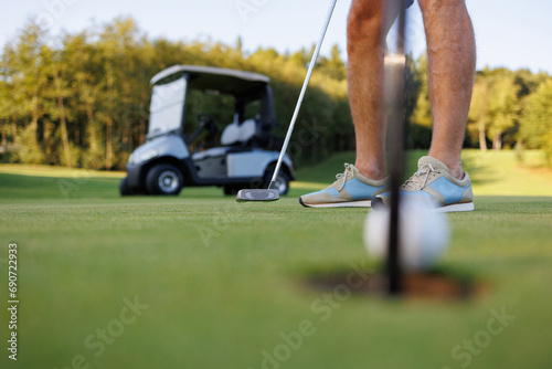 Golf Enthusiast: Man Playing with Cart in View