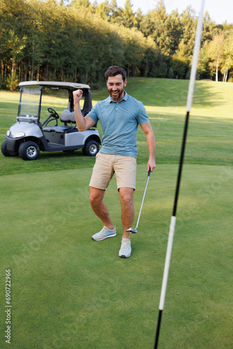 Youthful Golfer at Finish Flag with Golf Cart Beyond