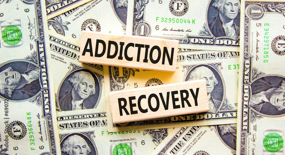 Addiction recovery symbol. Concept words Addiction recovery on beautiful wooden blocks. Dollar bills. Beautiful background from dollar bills. Psychology addiction recovery concept. Copy space.