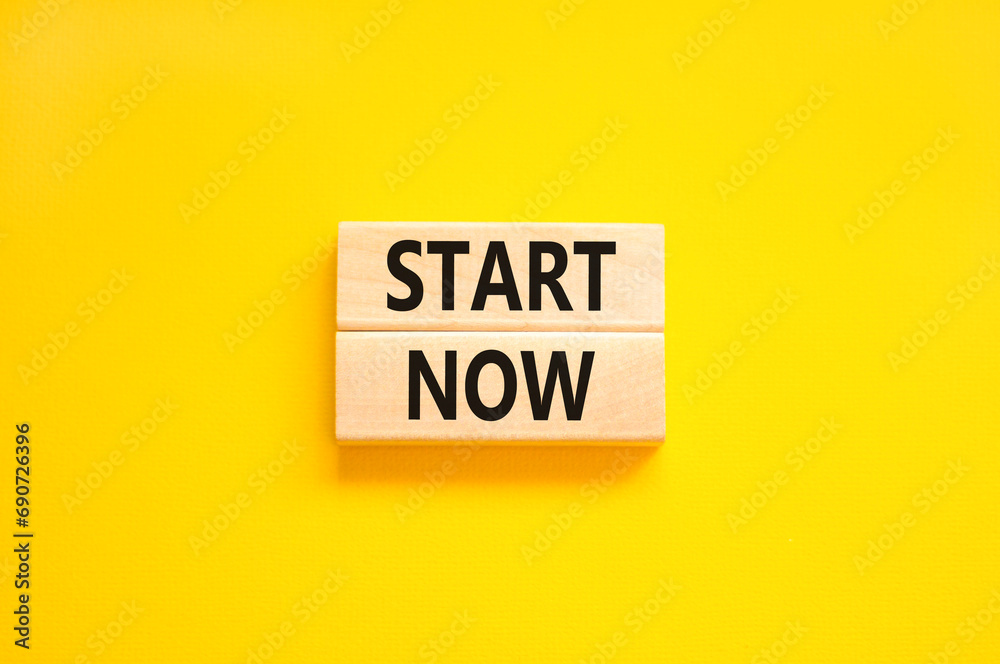 Start now symbol. Concept words Start now on beautiful wooden block. Beautiful yellow table yellow background. Business marketing, motivational start now concept. Copy space. Start now symbol. Concept words Start now on beautiful wooden block. Beautiful yellow table yellow background. Business marketing, motivational start now concept. Copy space.