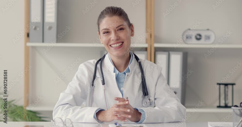 Friendly woman online doctor telehealth worker in glasses waves hello at office notebook PC, listens to patient, answers questions, gives medical advice, smiles and says goodbye at end of consultation Friendly woman online doctor telehealth worker in glasses waves hello at office notebook PC, listens to patient, answers questions, gives medical advice, smiles and says goodbye at end of consultation