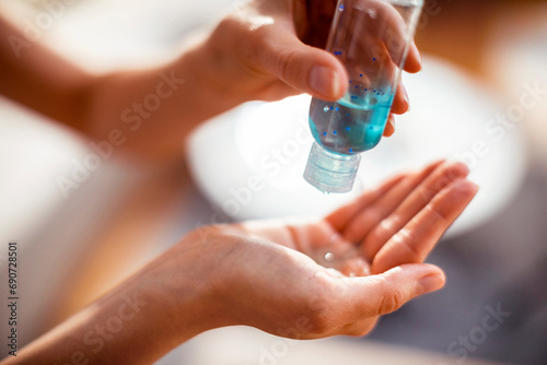 Close up woman using antibacterial hand sanitizer photo