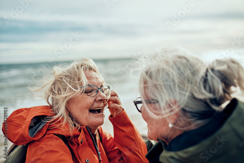 Happy senior women hugging on winter beach