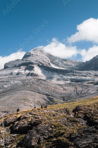 Group of mountaineers walking through the mountains with Monte Perdido in the background in the Pyrenees in summer