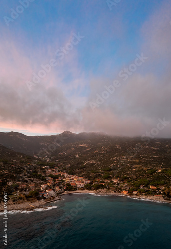 drone view of Seccheto Beach and village on Elba Island just after sunset with a misty purple sky © makasana photo