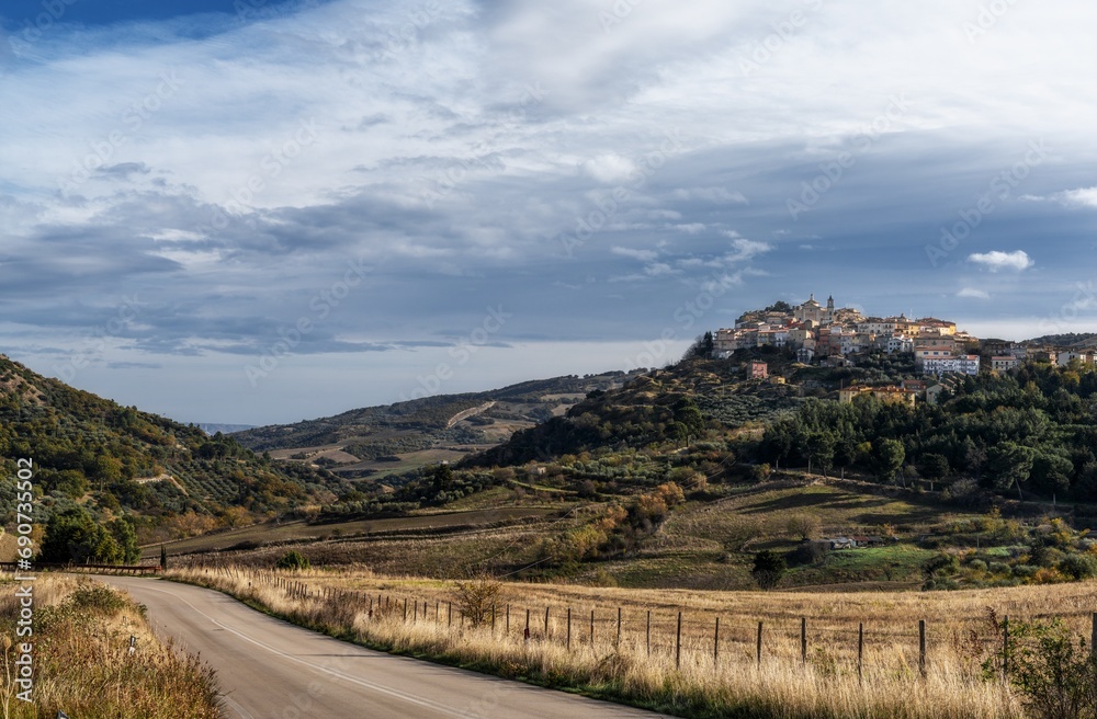 view of the town of Tolve in Basilicata with a country highway in the foreground