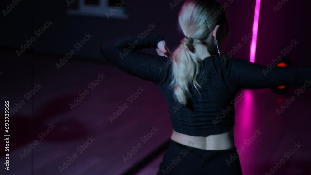 Live camera. Dancing woman. Close-up of active arm waving and gestures while performing the Waacking dance in a neon light hall Live camera. Dancing woman. Close-up of active arm waving and gestures while performing the Waacking dance in a neon light hall