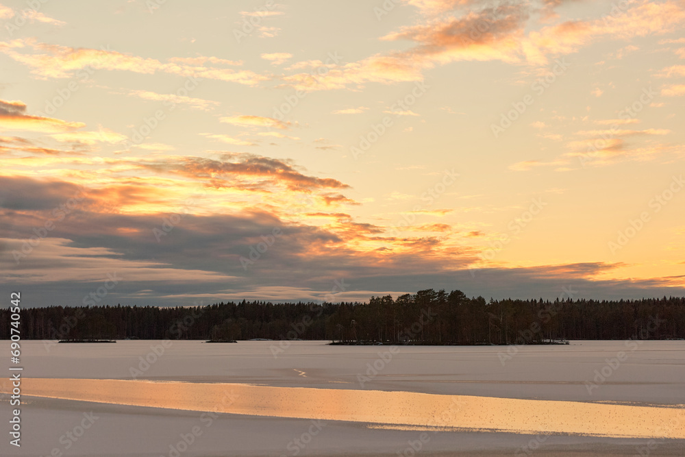 winter lake with snow at sunset