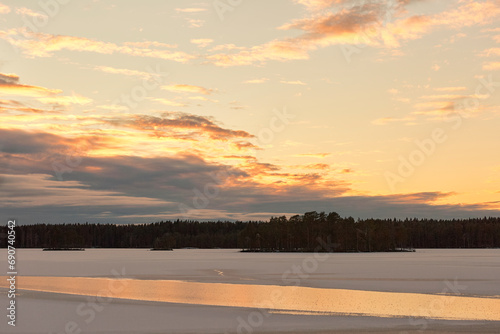 winter lake with snow at sunset