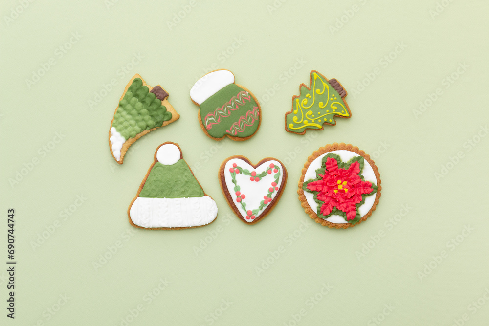 Delicious Christmas gingerbread cookies on a light green background. Top view.