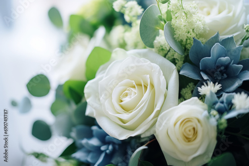 A stunning floral arrangement of white roses and blue succulents, offering a serene blend of color and texture for a sophisticated decor.