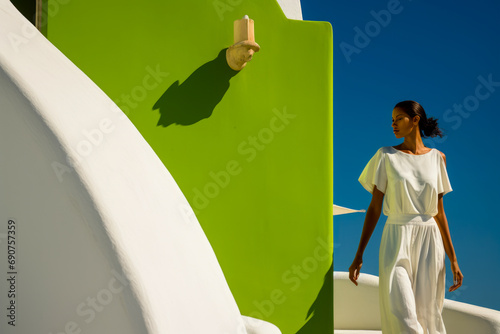 Fototapeta Naklejka Na Ścianę i Meble -  beautiful young model strolling along a Mediterranean island street