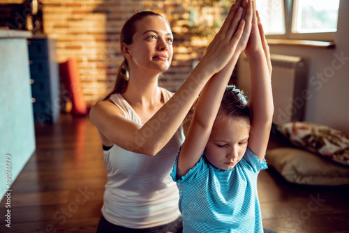 Mother and Daughter Practicing Yoga Together at Home