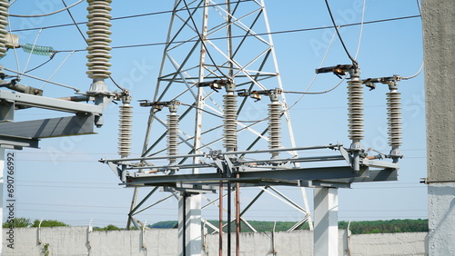 High and low voltage transformer bushings with electrical insulation and electrical equipment at a power substation. electrical equipment at the substation