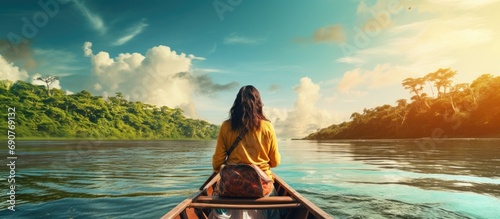 Woman explorer travels an Amazon river in a canoe. Copyspace image. Header for website template photo