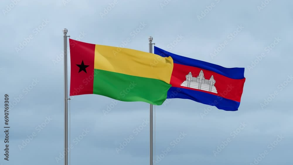 Cambodia flag and Guinea-Bissau flag waving together on cloudy sky, endless seamless loop, two country relations concept Cambodia flag and Guinea-Bissau flag waving together on cloudy sky, endless seamless loop, two country relations concept