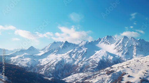 Snow covered mountain range with a clear blue sky in the background. Perfect for outdoor adventure or winter landscape themes © Fotograf