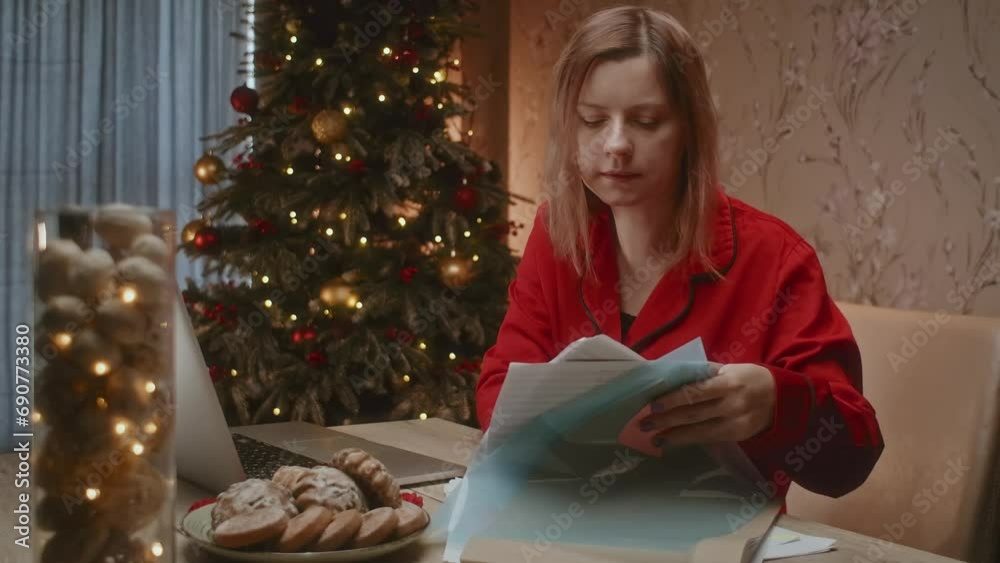 Woman working on Christmas Eve at home, overworked person with mental
