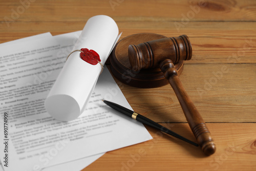 Notary contract. Documents, gavel and pen on wooden table photo