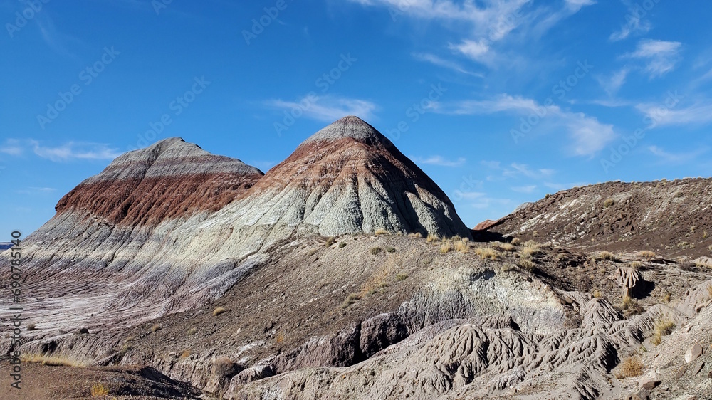 This photo captures a unique and beautiful striped mountain in Arizona. The colorful layers of sediment create a stunning pattern on the peak