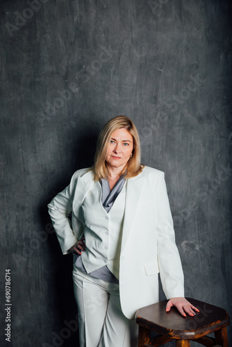 Adult woman in white business suit © dmitriisimakov